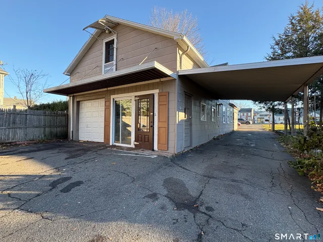 a view of a house with backyard and balcony