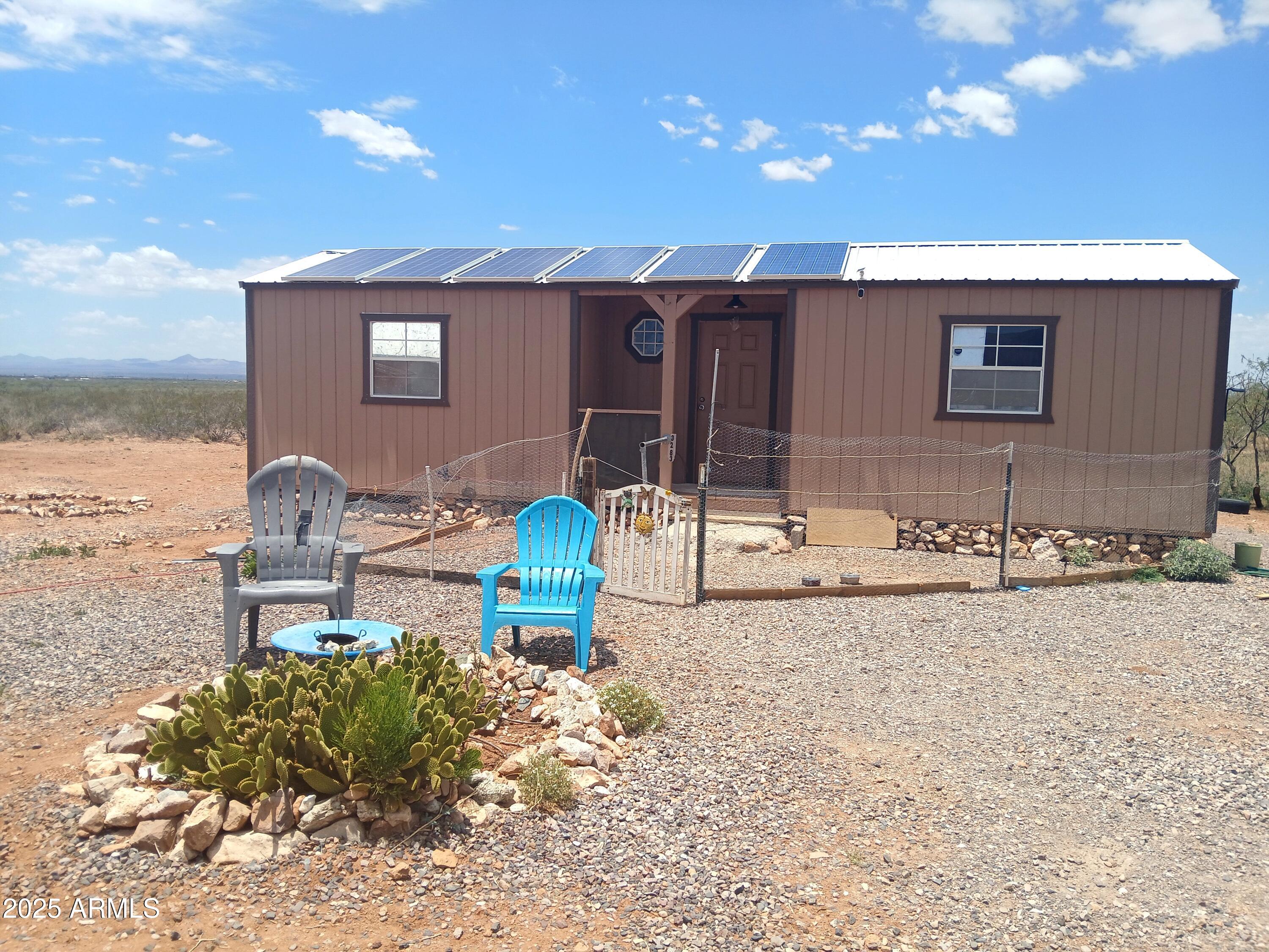 3283 C. Los Vientos Douglas, AZ 85607 - Photo 2 of 20 a front view of a house with garden