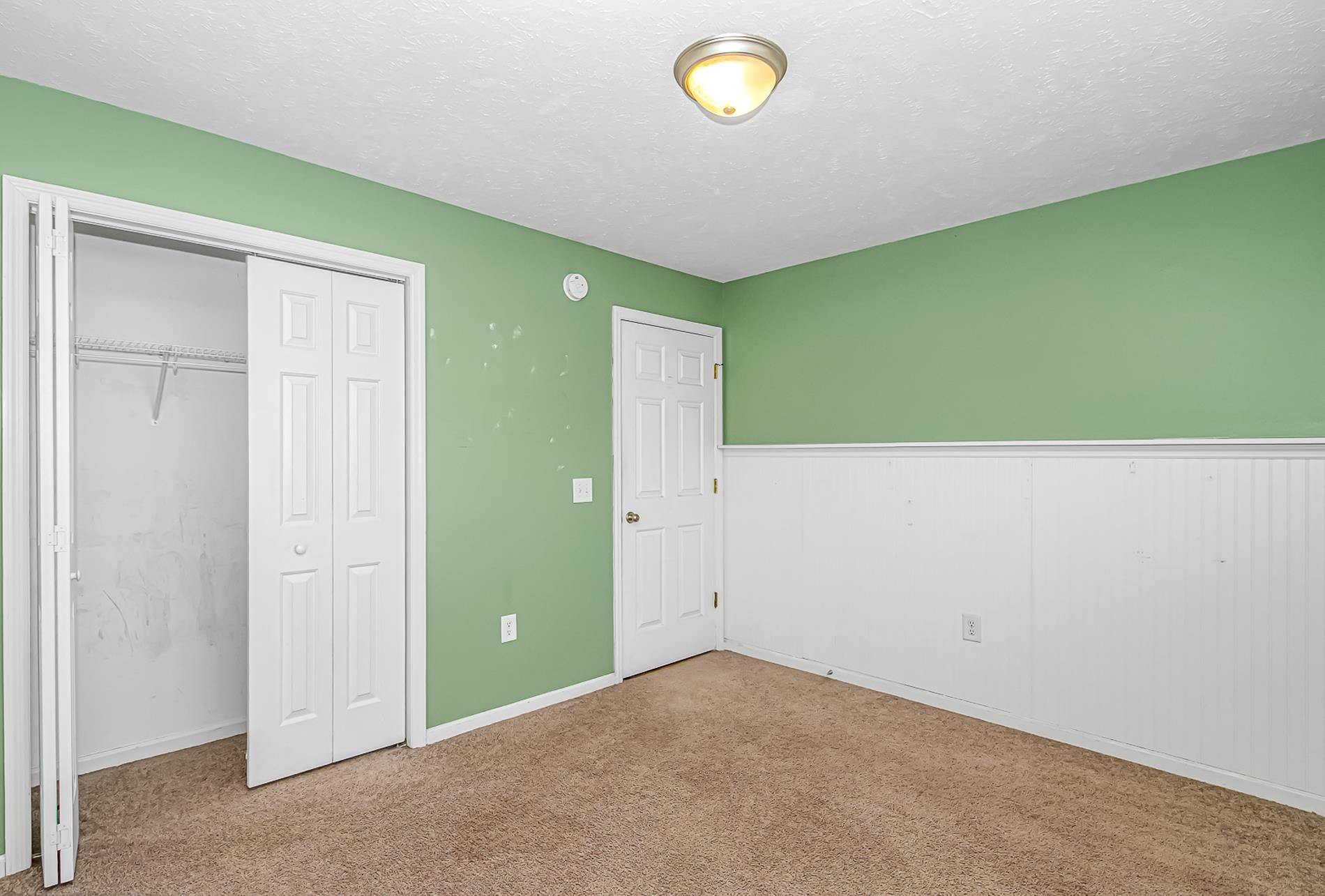 1012 Cadbury Court Conway, SC 29527 - Photo 26 of 40 Unfurnished bedroom with a textured ceiling, carpet floors, a closet, and wainscoting