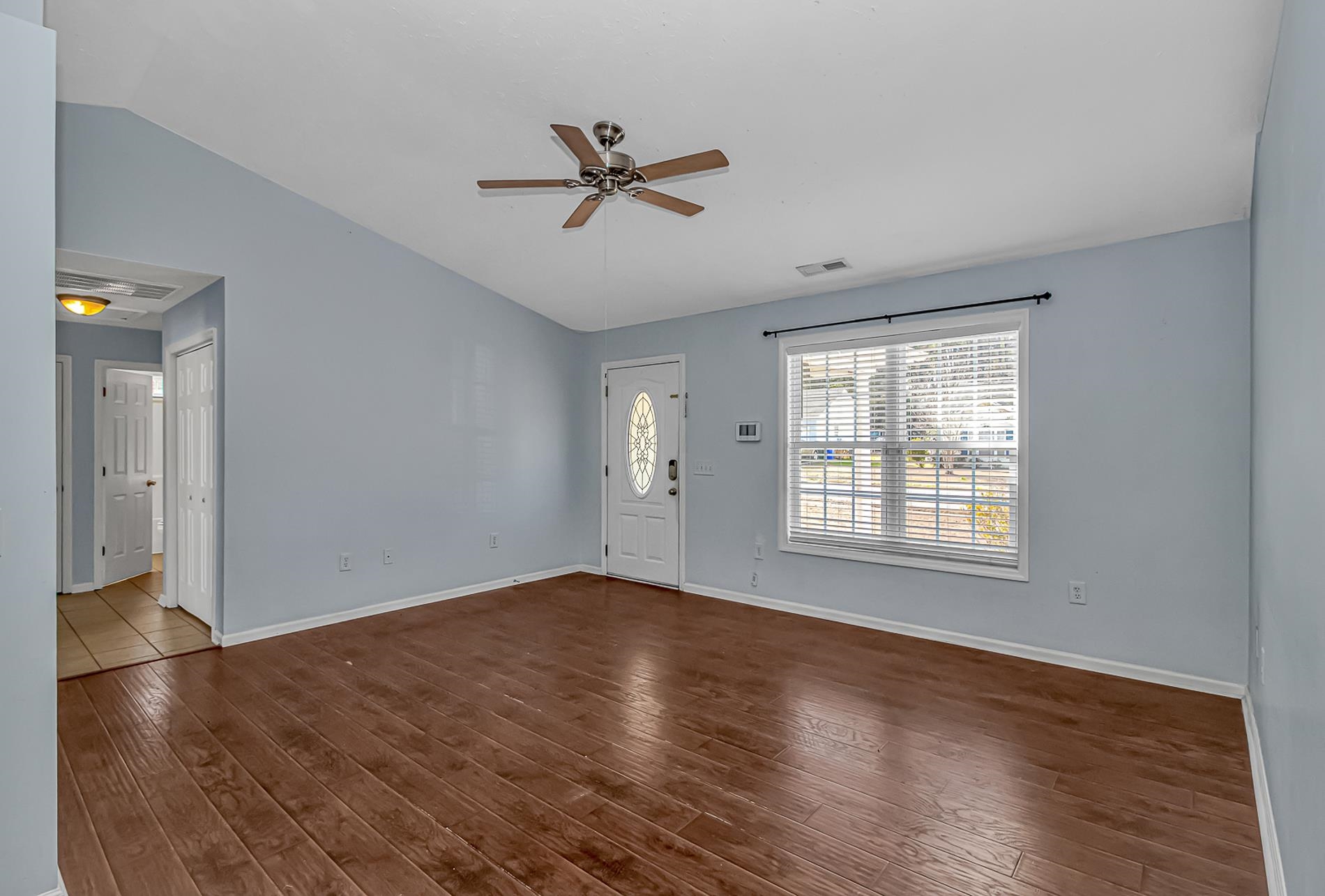 1012 Cadbury Court Conway, SC 29527 - Photo 10 of 40 Unfurnished living room featuring hardwood / wood-style flooring, ceiling fan, and vaulted ceiling