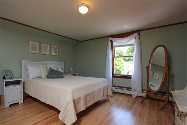18 Walnut Road Hamilton, MA 01982 - Photo 10 of 14 a bedroom with a bed and a mirror
