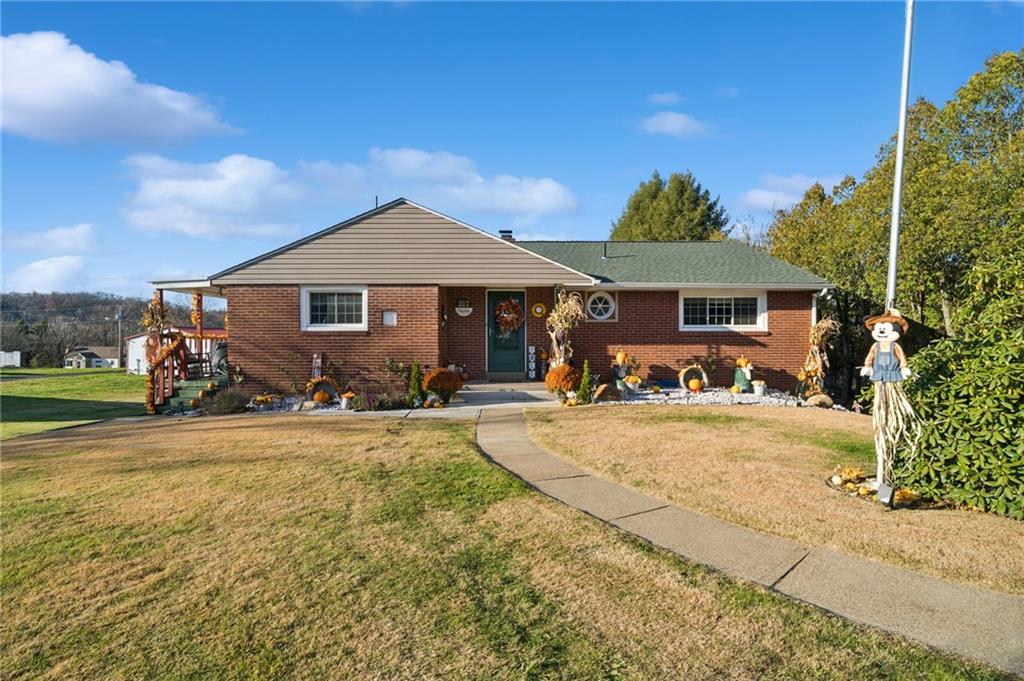 a front view of a house with yard patio and garage