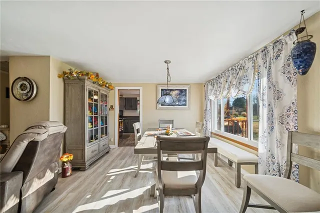 a living room with furniture a flat screen tv and a window