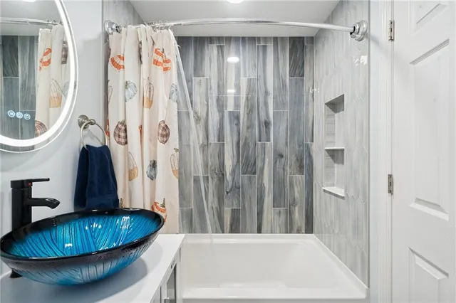 a bathroom with a tub and a shower
