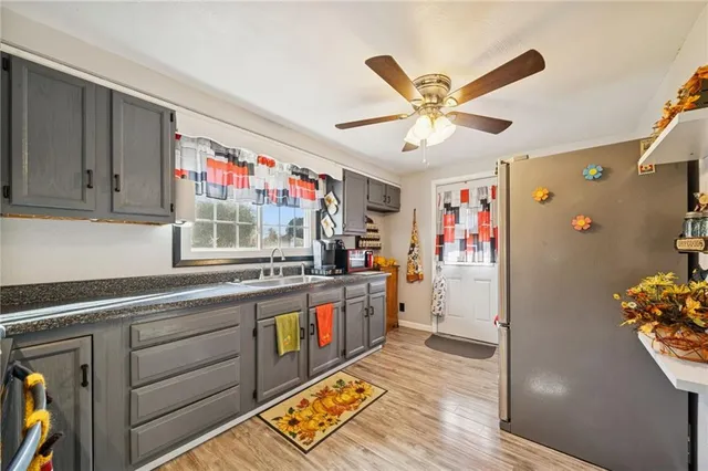 a kitchen with stainless steel appliances granite countertop a refrigerator and a sink