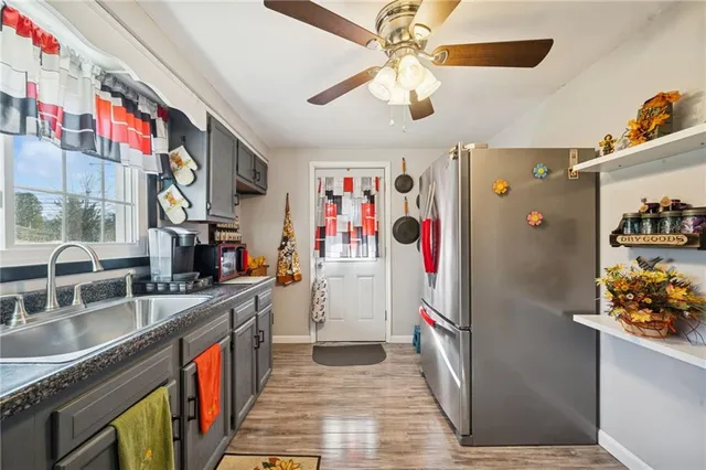 a kitchen with stainless steel appliances granite countertop a refrigerator a stove and a sink