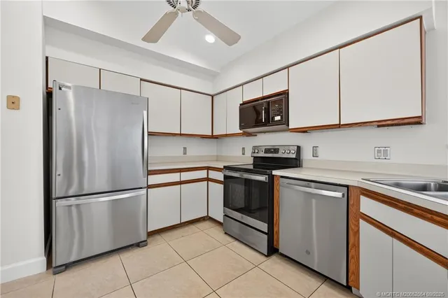 a kitchen with cabinets stainless steel appliances and a counter space