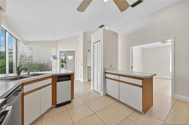a large kitchen with kitchen island granite countertop a sink and a refrigerator