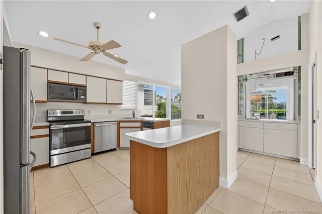 a kitchen with a sink stove and microwave