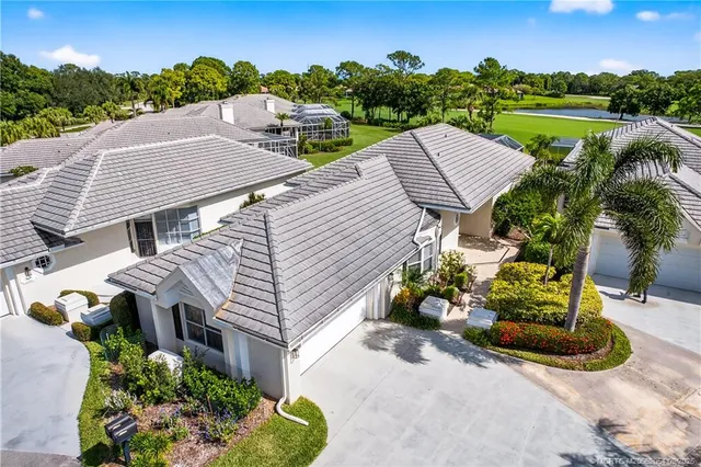 an aerial view of a house with a yard and lake view
