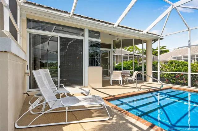a view of a patio with table and chairs and potted plants