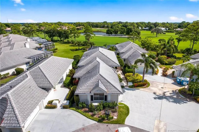 an aerial view of multiple houses with a yard