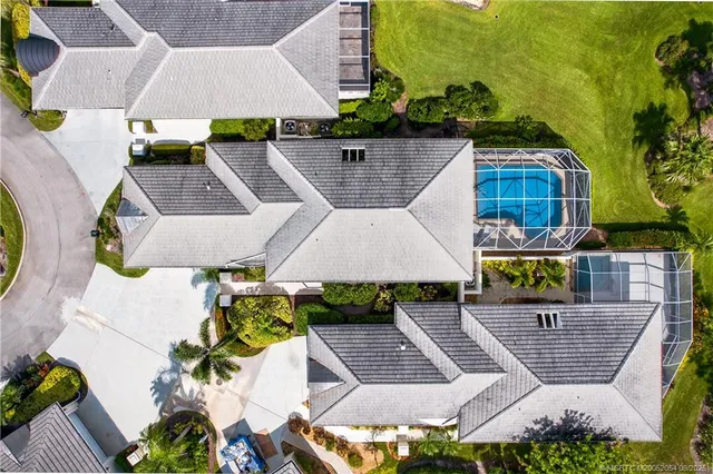 an aerial view of multiple houses with yard