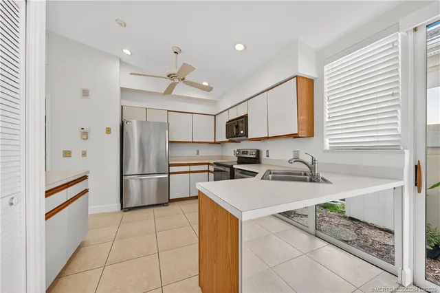 a kitchen with a refrigerator a sink and a stove