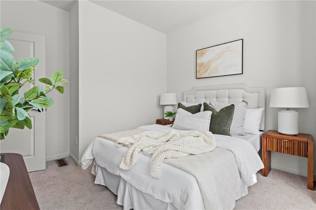 718 Needletail Way Atlanta, GA 30312 - Photo 26 of 44 a bedroom with bed and a potted plant