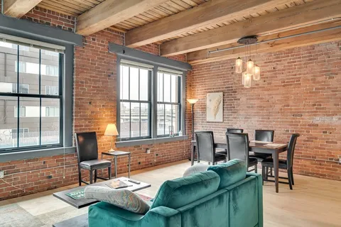 a dining room with furniture and windows