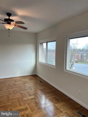 a view of a livingroom with a ceiling fan and window