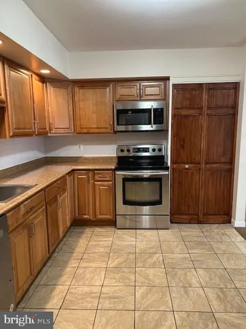 a kitchen with a stove a sink and a microwave
