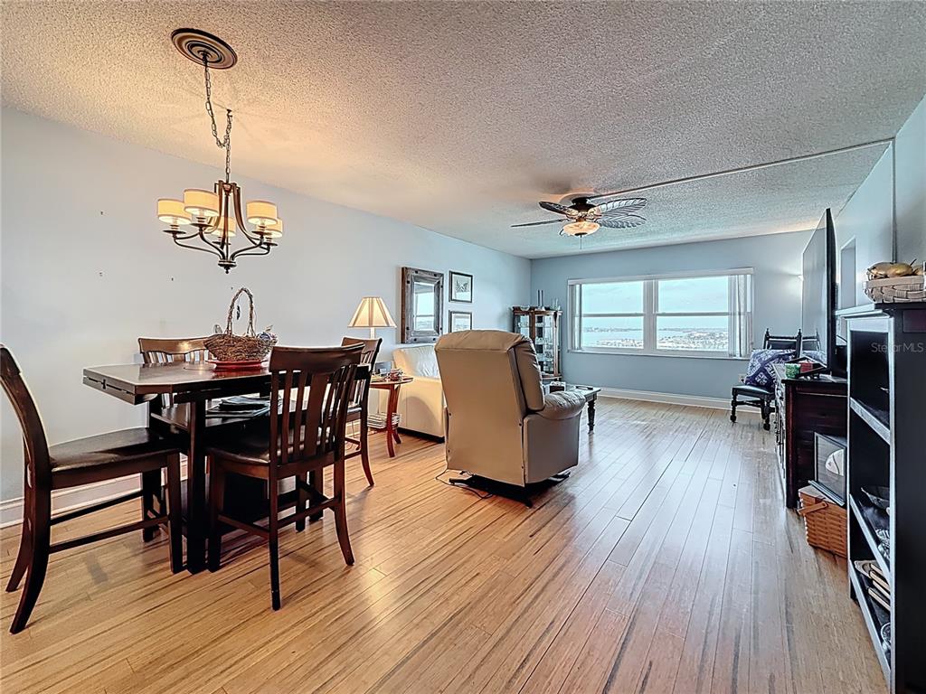 4725 Cove Circle, Unit 908 St. Petersburg, FL 33708 - Photo 19 of 61 a view of a dining room with furniture and wooden floor
