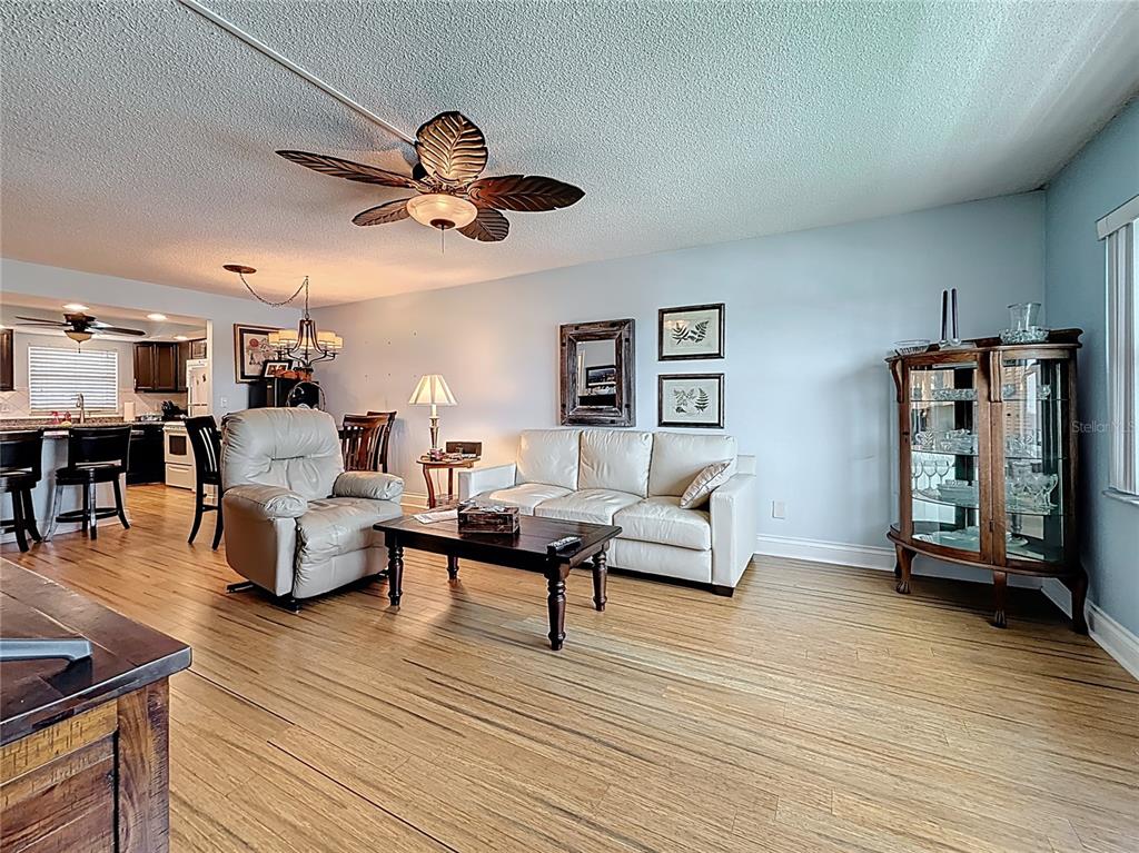 4725 Cove Circle, Unit 908 St. Petersburg, FL 33708 - Photo 21 of 61 a living room with furniture and a wooden floor