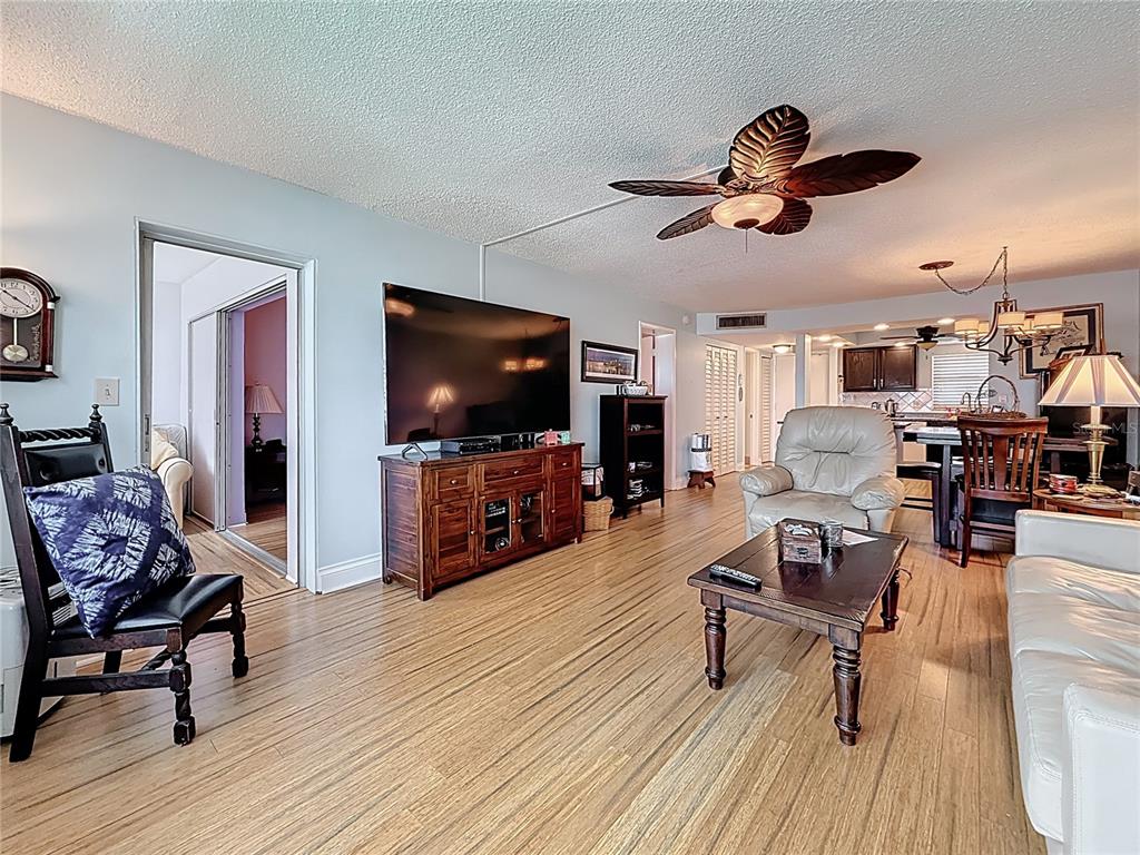4725 Cove Circle, Unit 908 St. Petersburg, FL 33708 - Photo 22 of 61 a living room with furniture and a flat screen tv