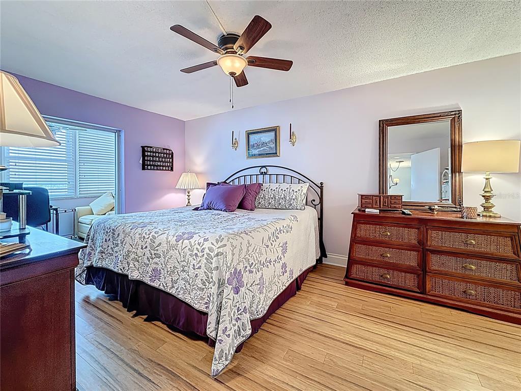4725 Cove Circle, Unit 908 St. Petersburg, FL 33708 - Photo 24 of 61 a bedroom with a large bed and a chandelier