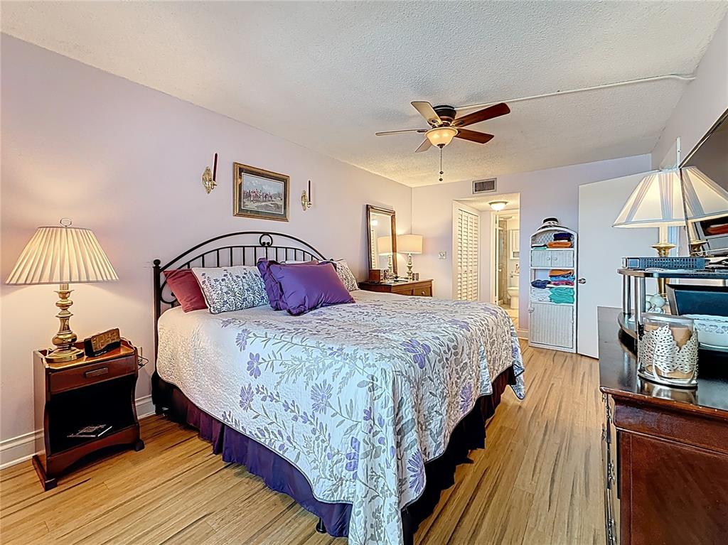 4725 Cove Circle, Unit 908 St. Petersburg, FL 33708 - Photo 26 of 61 a bedroom with bed and a chandelier