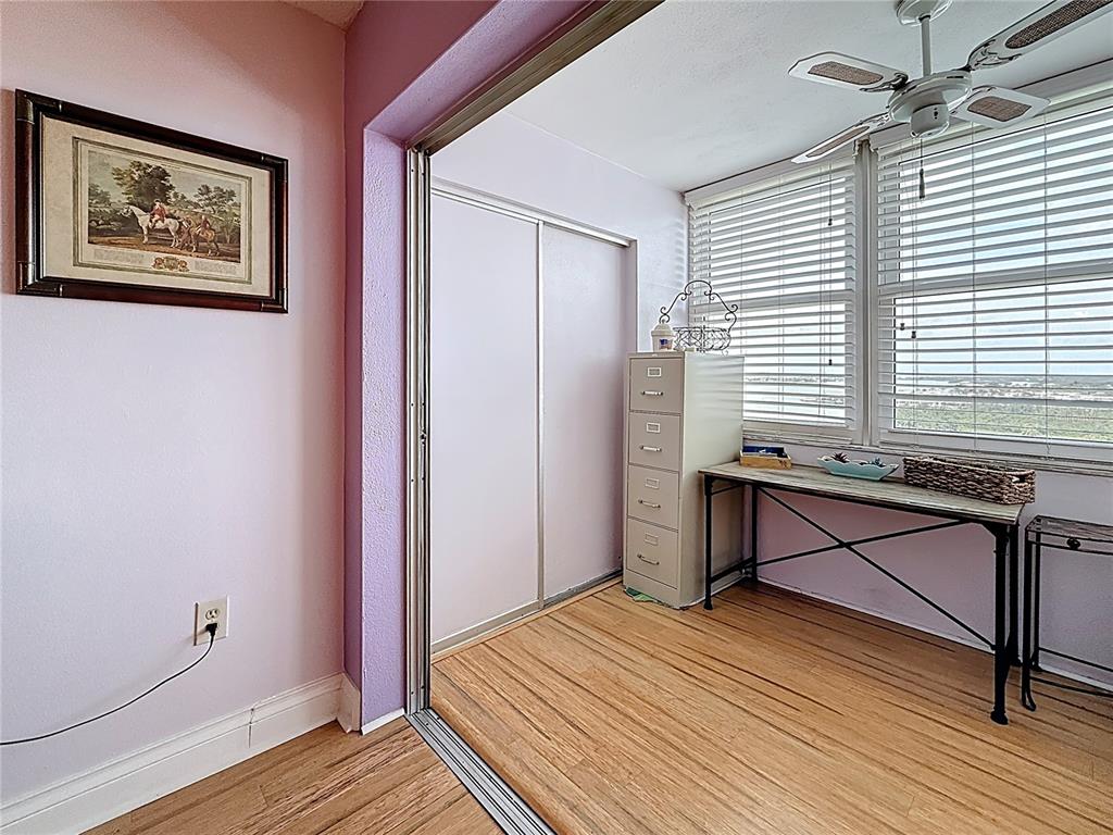 4725 Cove Circle, Unit 908 St. Petersburg, FL 33708 - Photo 27 of 61 a view of a bedroom with wooden floor and a window