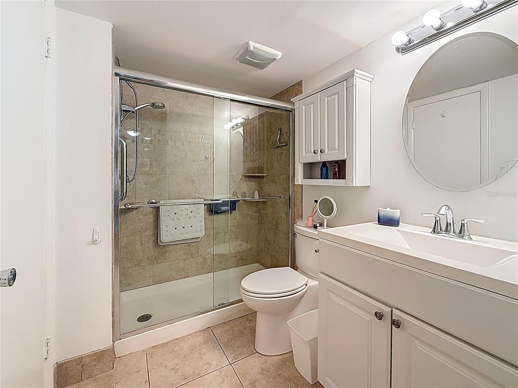 4725 Cove Circle, Unit 908 St. Petersburg, FL 33708 - Photo 30 of 61 a bathroom with a sink a toilet and shower