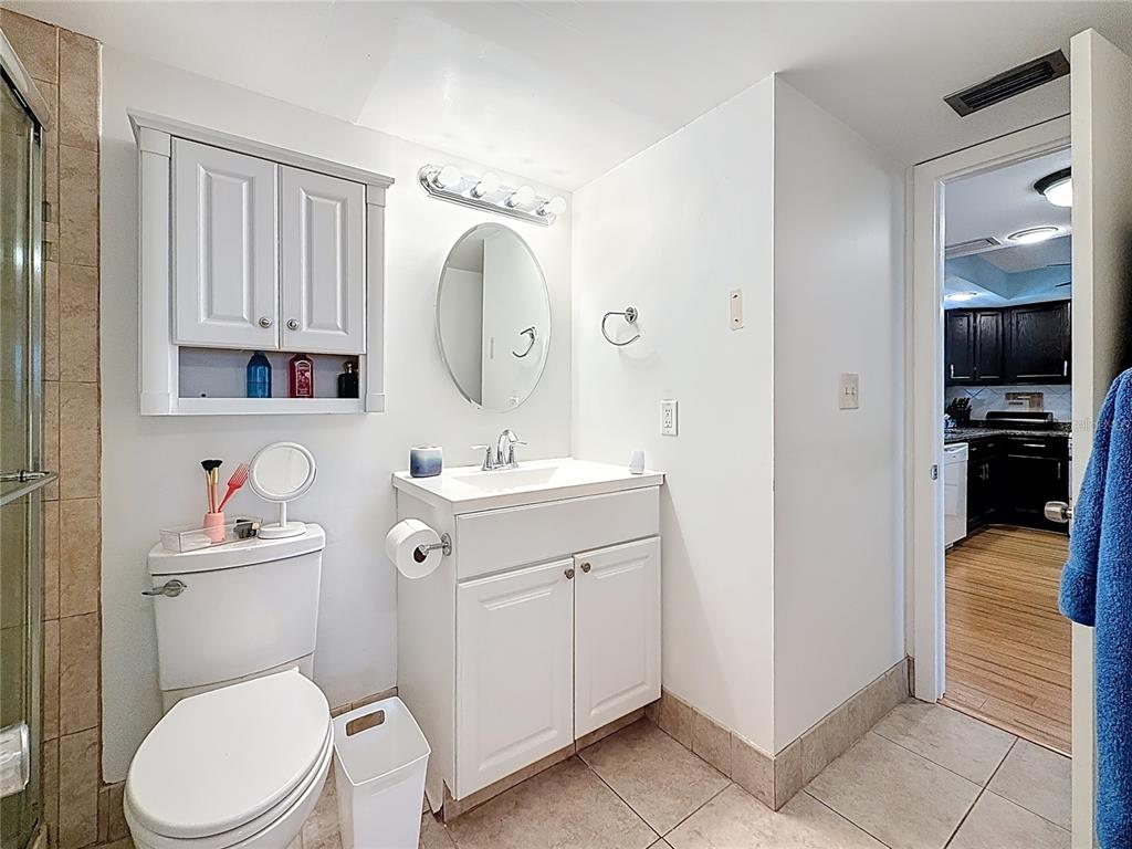 4725 Cove Circle, Unit 908 St. Petersburg, FL 33708 - Photo 31 of 61 a bathroom with a toilet sink and mirror