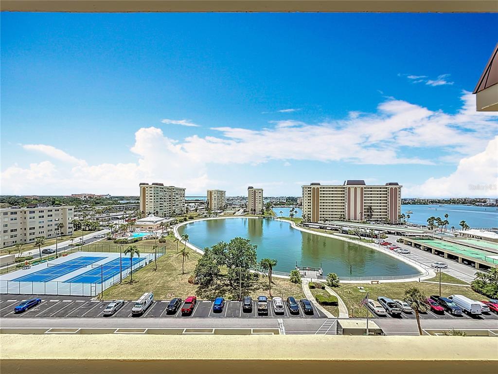 4725 Cove Circle, Unit 908 St. Petersburg, FL 33708 - Photo 37 of 61 a view of a swimming pool with a lake view