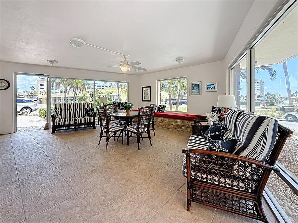4725 Cove Circle, Unit 908 St. Petersburg, FL 33708 - Photo 38 of 61 a living room with furniture and a large window