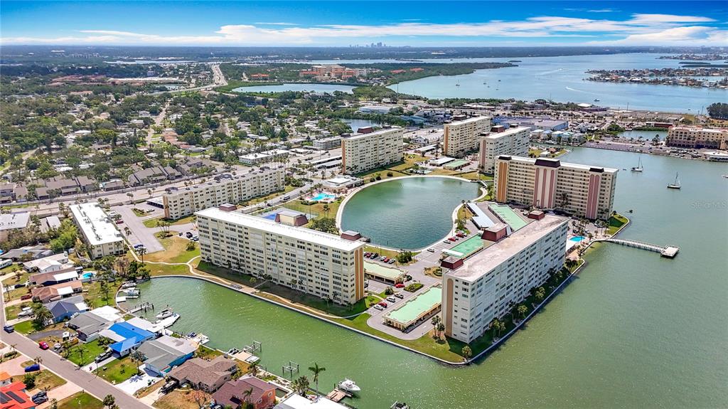 4725 Cove Circle, Unit 908 St. Petersburg, FL 33708 - Photo 46 of 61 a view of a lake with a nearby beach