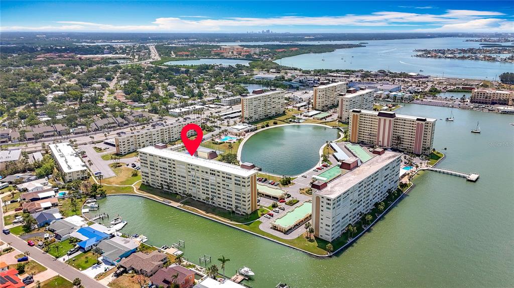 4725 Cove Circle, Unit 908 St. Petersburg, FL 33708 - Photo 5 of 61 a view of a lake with a nearby beach
