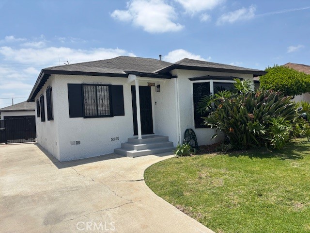 1704 West 138th Street Compton, CA 90222 - Photo 1 of 1 a view of a house with a small yard and a large tree