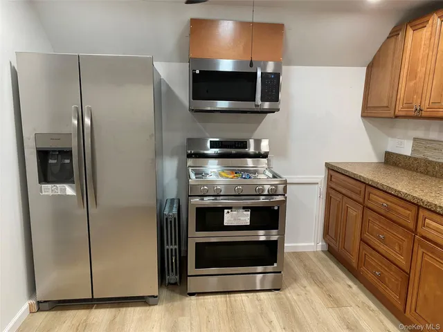 a kitchen with stainless steel appliances a stove a microwave and a refrigerator