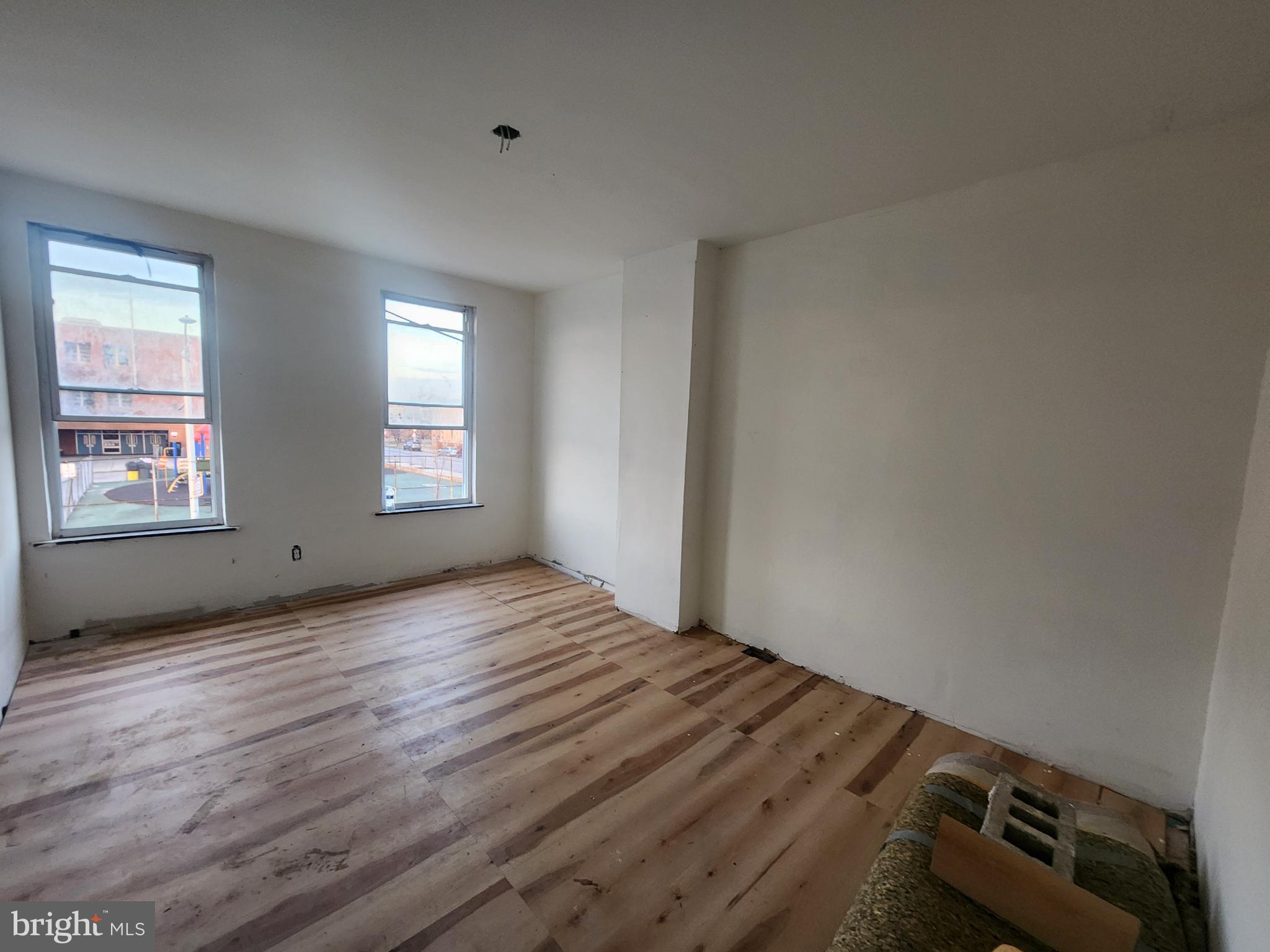 409 South Pulaski Street Baltimore, MD 21223 - Photo 9 of 9 a view of empty room with wooden floor and fan