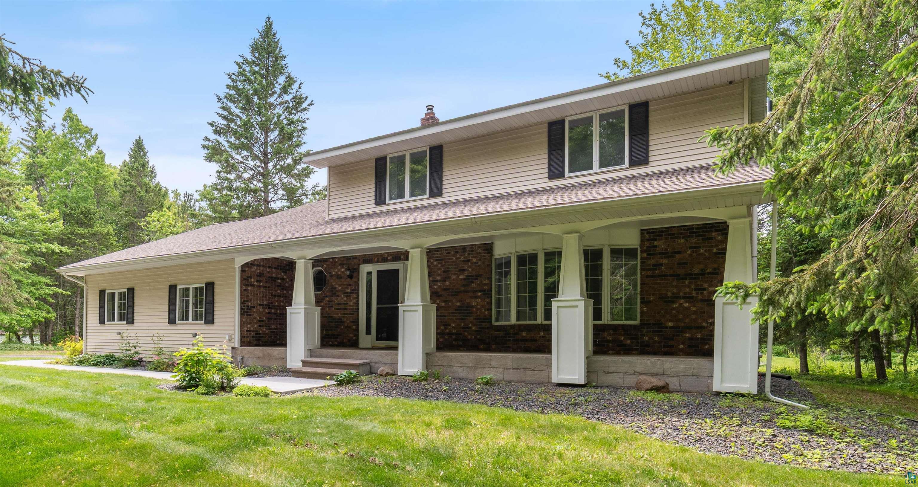 4283 Birch Valley Road Hermantown, MN 55811 - Photo 1 of 48 View of front of property featuring covered porch, a front lawn, a chimney, and brick siding