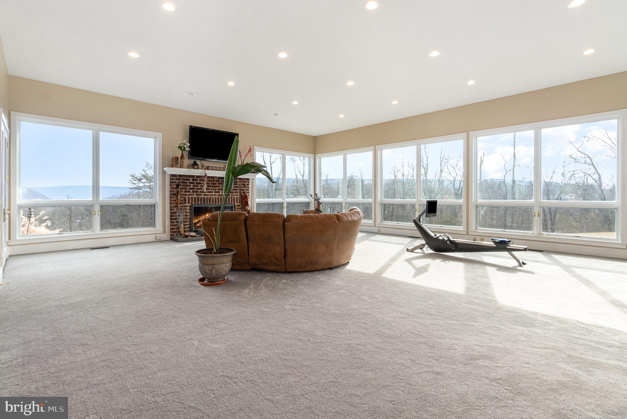 14 Faculty Road Duncannon, PA 17020 - Photo 19 of 62 a living room with furniture a flat screen tv and floor to ceiling window