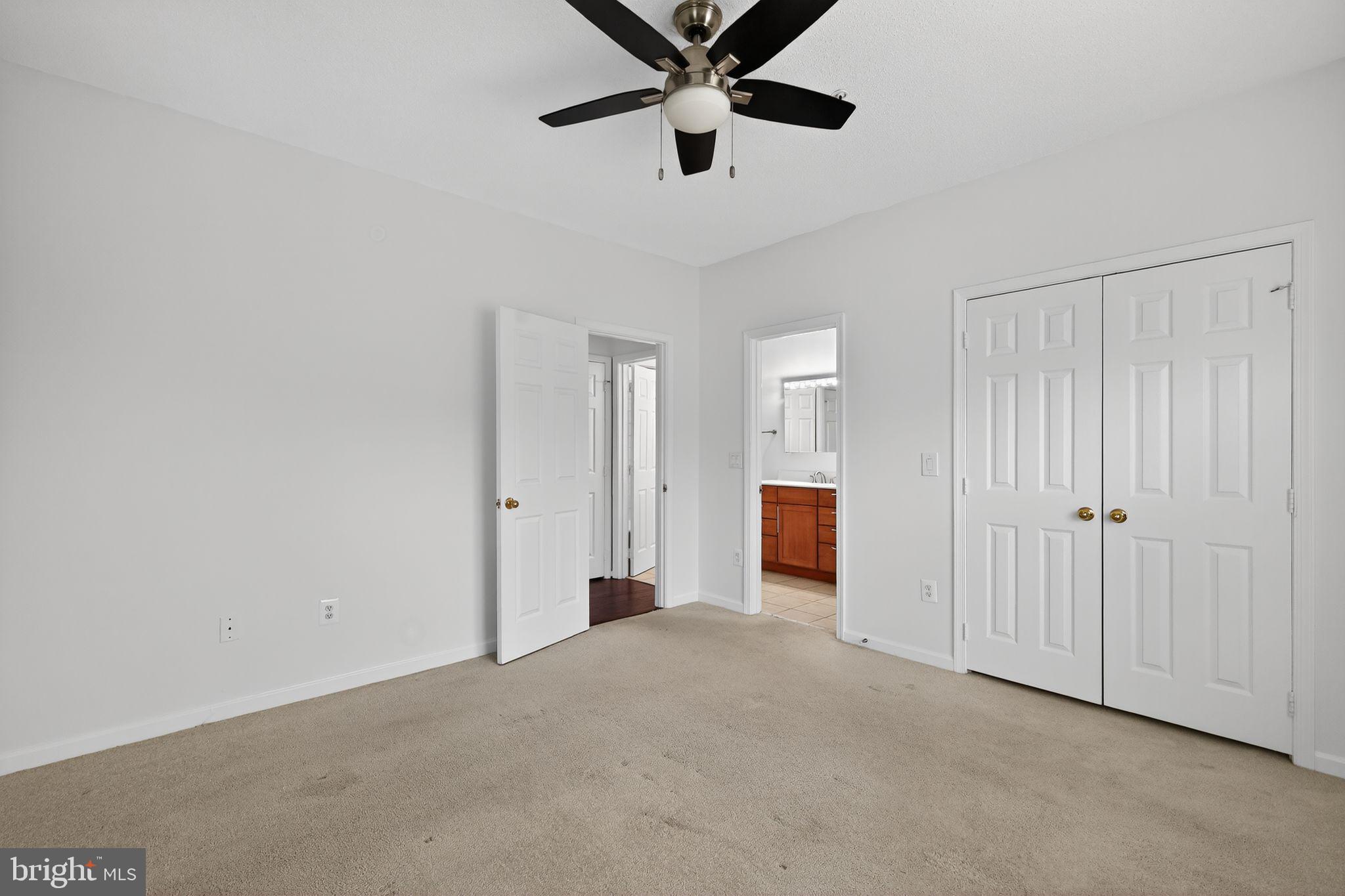 12016 Taliesin Place, Unit 26 Reston, VA 20190 - Photo 19 of 30 a view of a livingroom with a ceiling fan & a ceiling fan