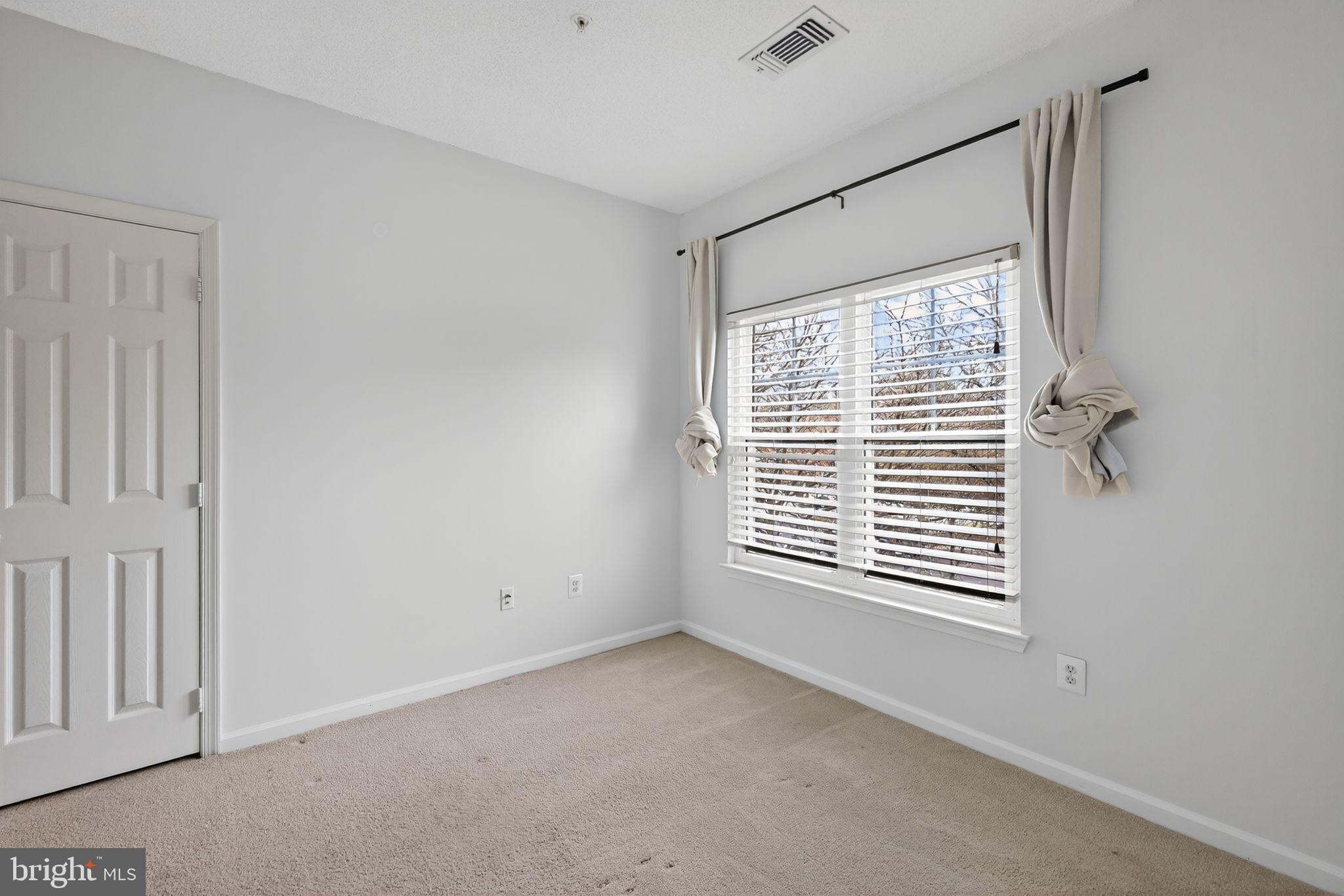 12016 Taliesin Place, Unit 26 Reston, VA 20190 - Photo 21 of 30 a view of an empty room with a window