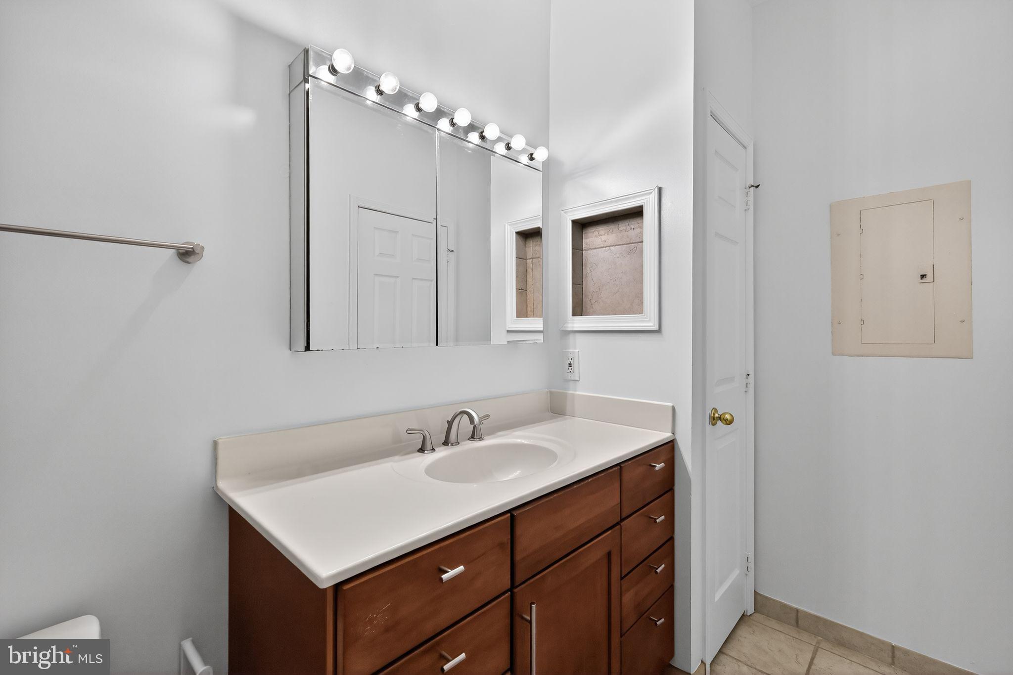 12016 Taliesin Place, Unit 26 Reston, VA 20190 - Photo 26 of 30 a bathroom with a sink vanity and mirror