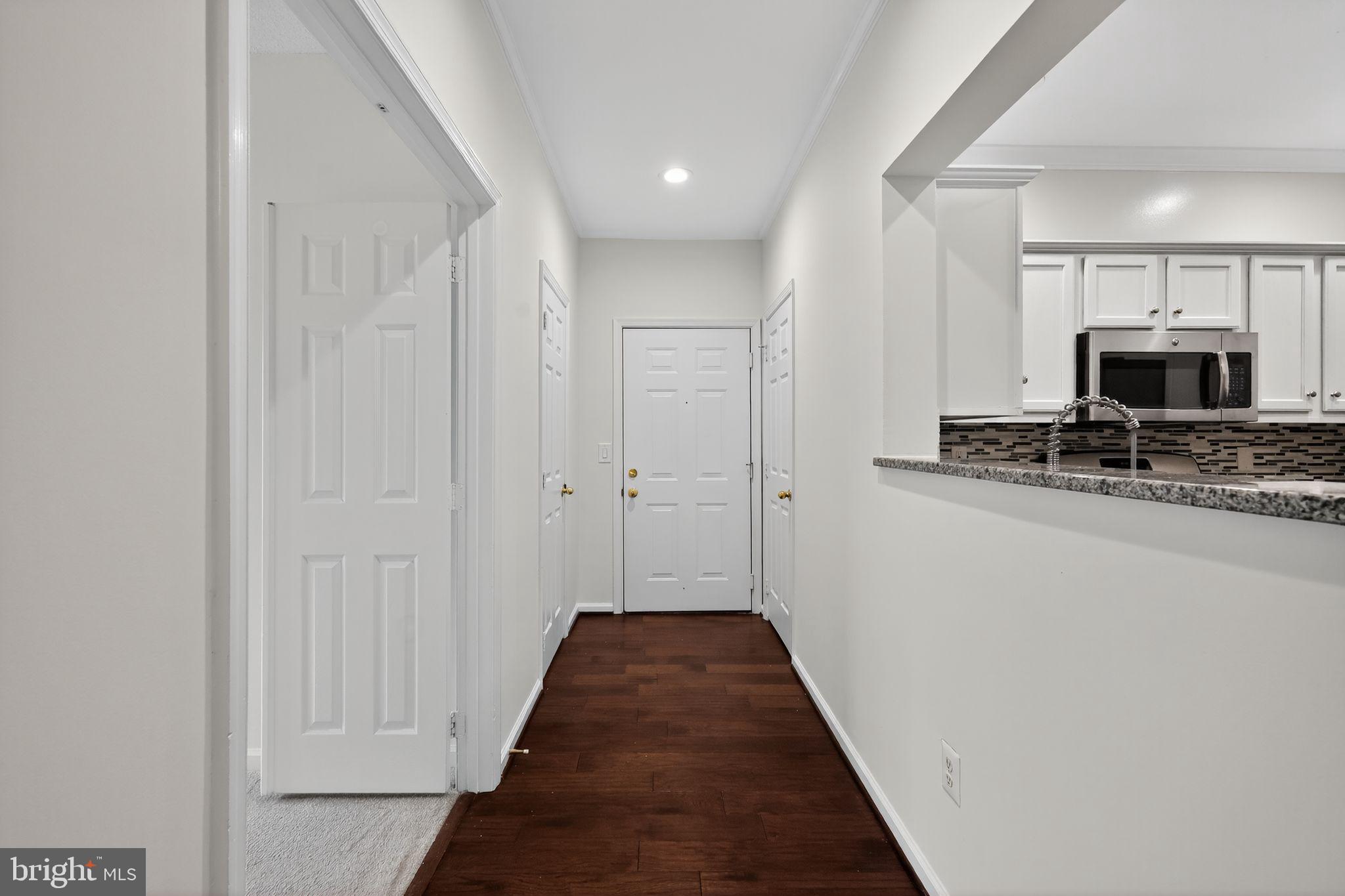 12016 Taliesin Place, Unit 26 Reston, VA 20190 - Photo 4 of 30 a view of a hallway with wooden floor and staircase
