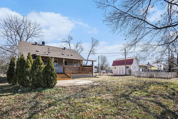 a view of a large house with a big yard and large trees