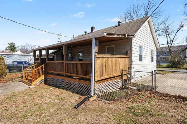 a view of a house with wooden fence