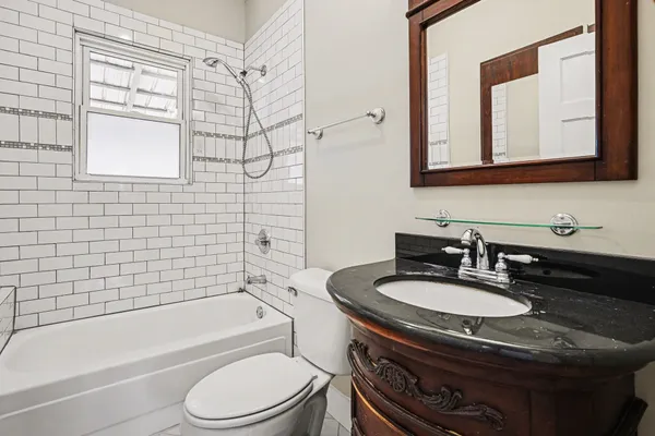 a bathroom with a sink a toilet and bathtub