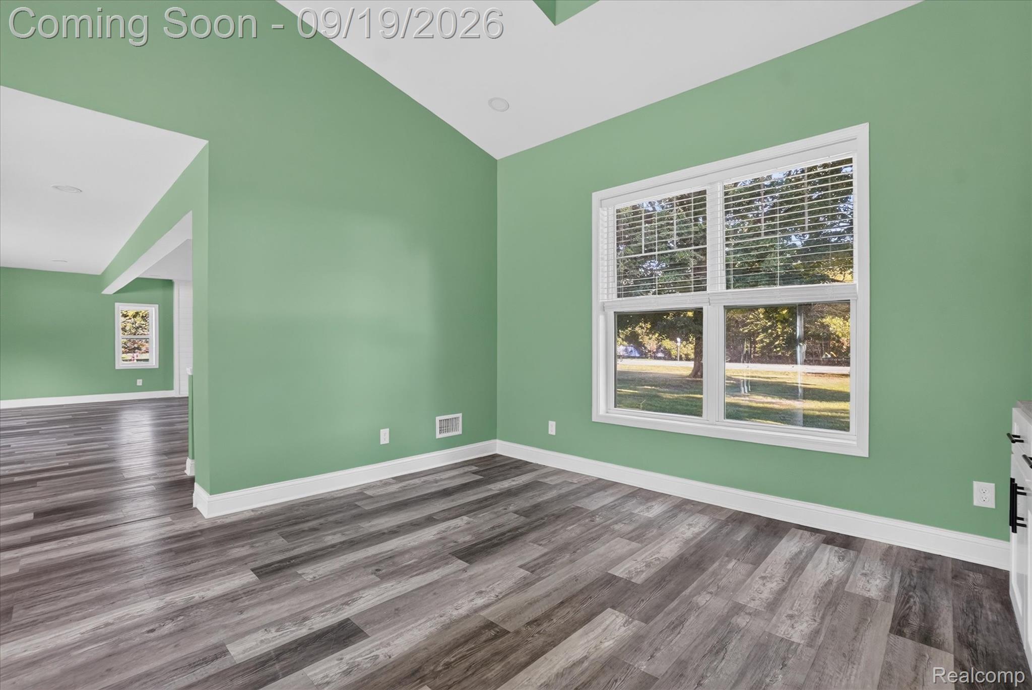 10215 West Mount Morris Road Flushing, MI 48433 - Photo 12 of 58 Vaulted ceiling, recessed lighting, large window with blinds, wood-finish flooring, and white trim