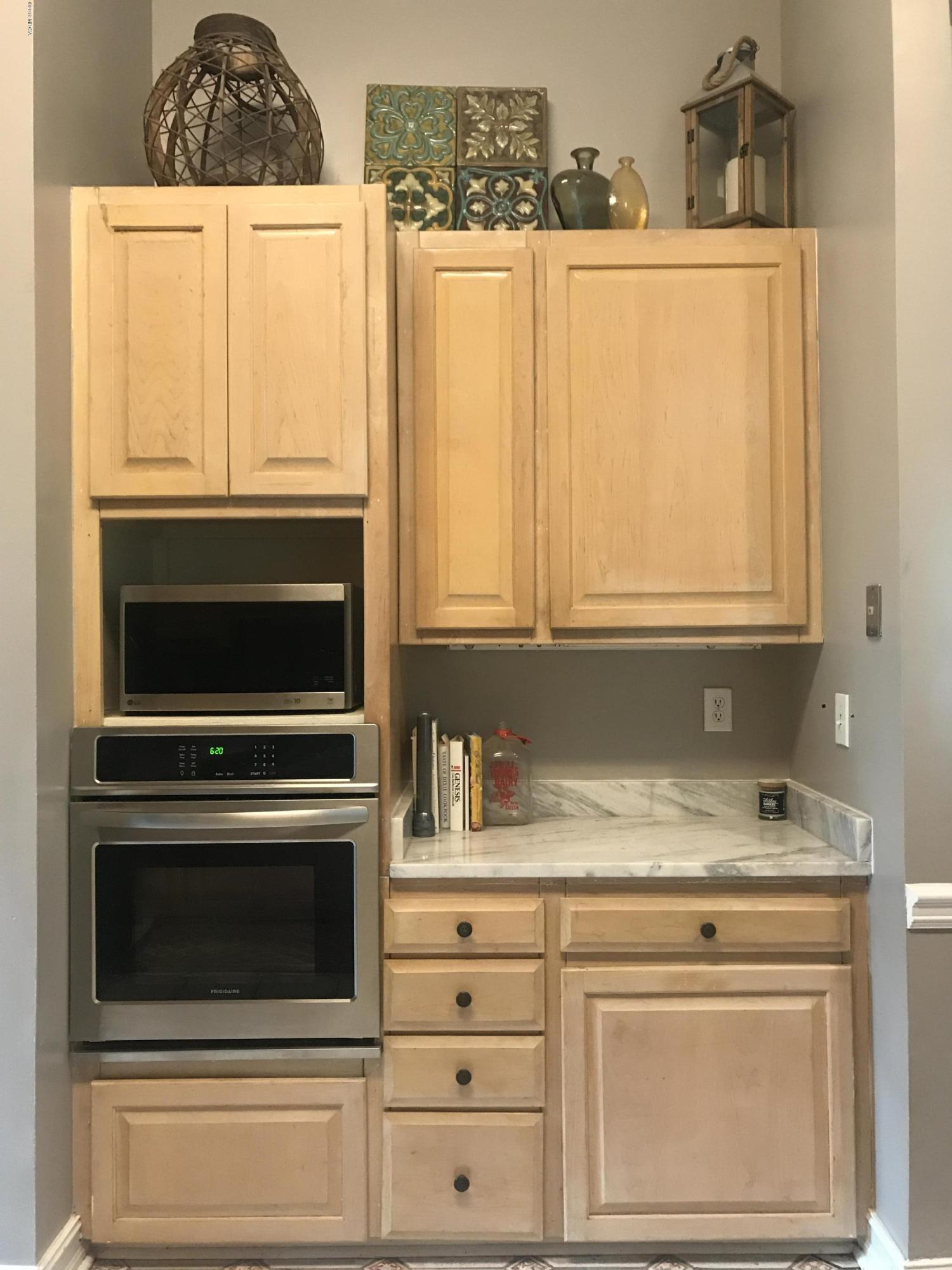 1569 Johnson Road Macon, GA 31220 - Photo 11 of 28 a kitchen with granite countertop white cabinets and white appliances