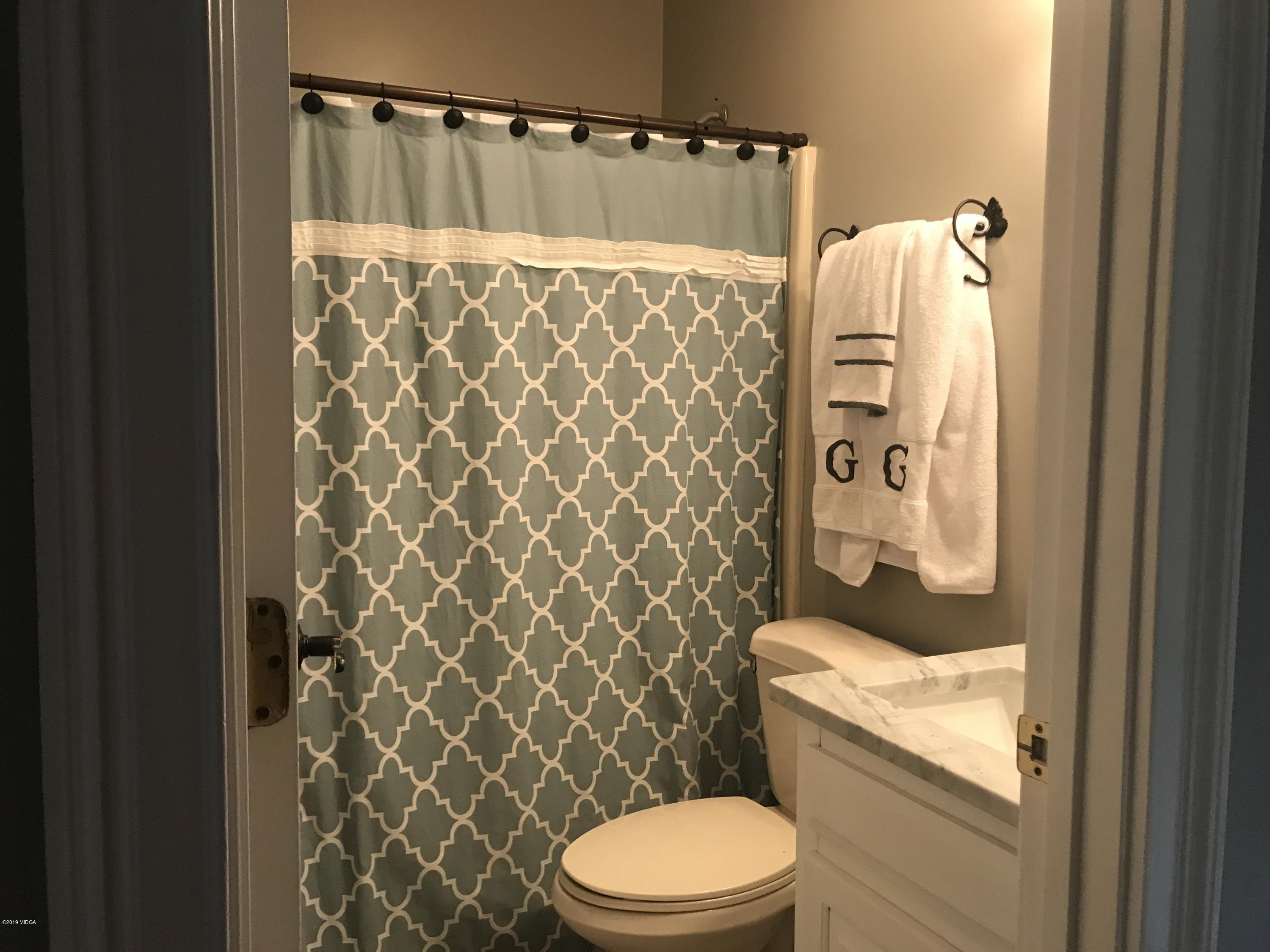 1569 Johnson Road Macon, GA 31220 - Photo 12 of 28 a bathroom with a toilet and shower curtain