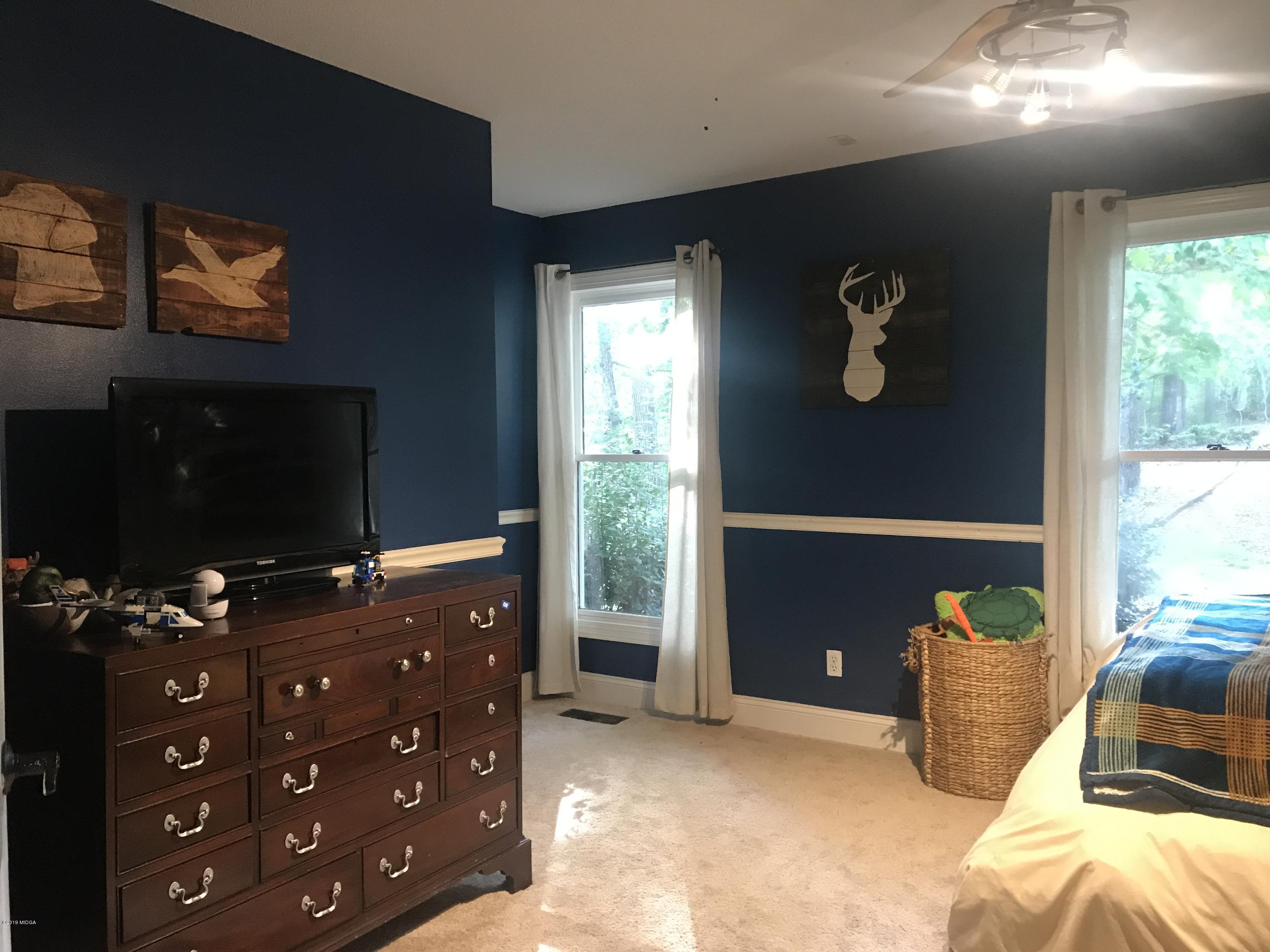 1569 Johnson Road Macon, GA 31220 - Photo 14 of 28 a bedroom with a bed and a television
